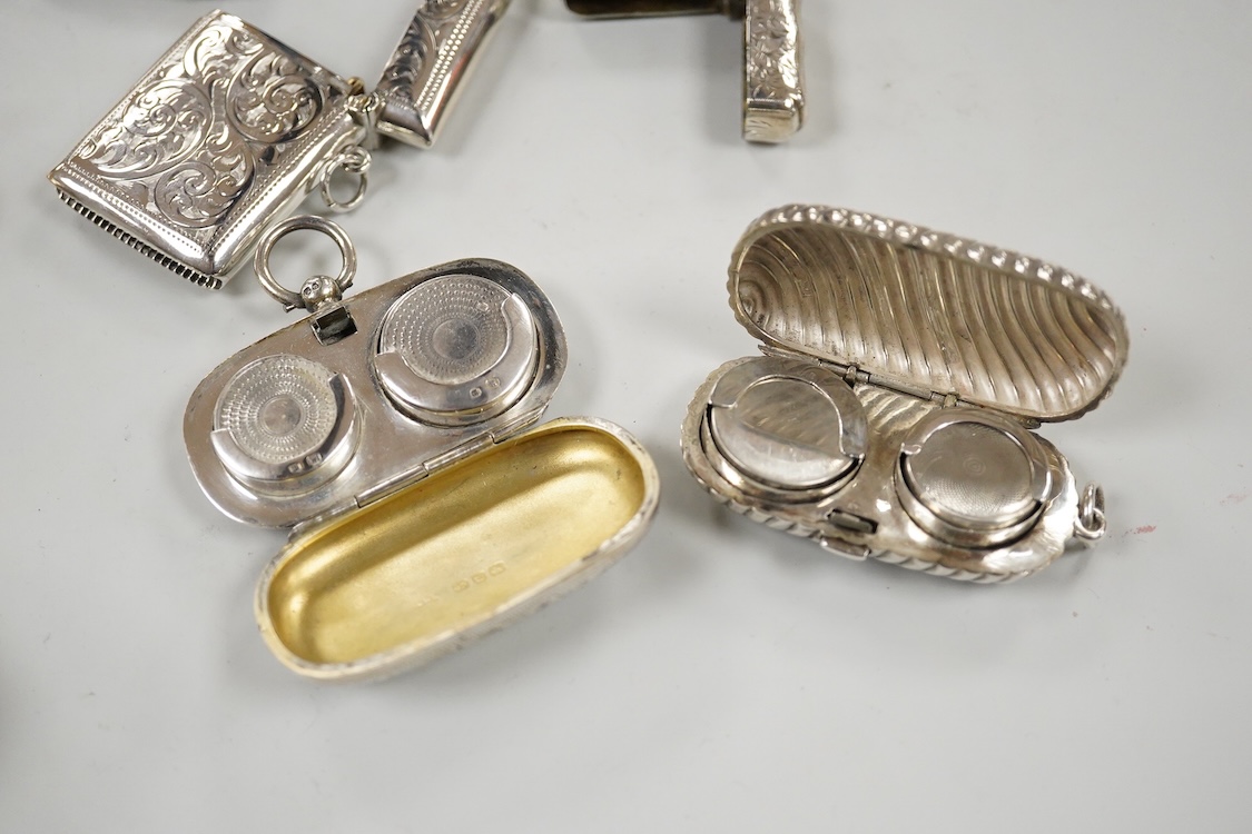 Two late Victorian silver twin compartment sovereign cases, Birmingham, 1891 & 1896, both approx. 57mm, a gold plated sovereign case, together with three silver vesta cases, a silver purse and a silver mounted notebook.